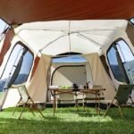 Roomy interior of large automatic camping tent with space for picnic setup.
