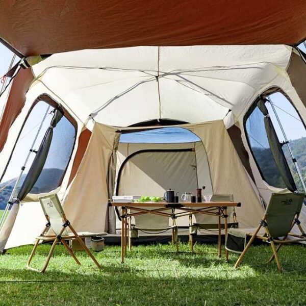 Roomy interior of large automatic camping tent with space for picnic setup.