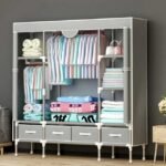 Large clothes closet in grey placed in living room and holding shirts, towels, and blankets securely.