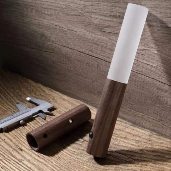 Motion sensor night light in dark brown, crafted from ash wood and plexiglass for stylish durability.