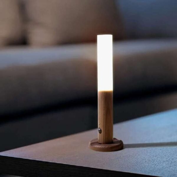 Motion sensor night light on living room table, versatile for wall or table use.