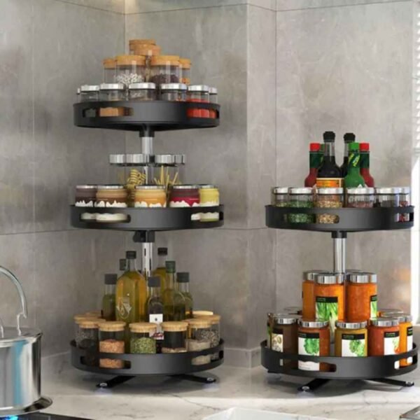 Rotating spice racks holding seasonings and spices on kitchen counter.