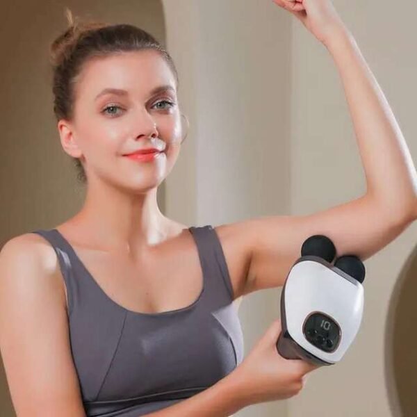 Woman using double head massage gun to relieve arm pain.