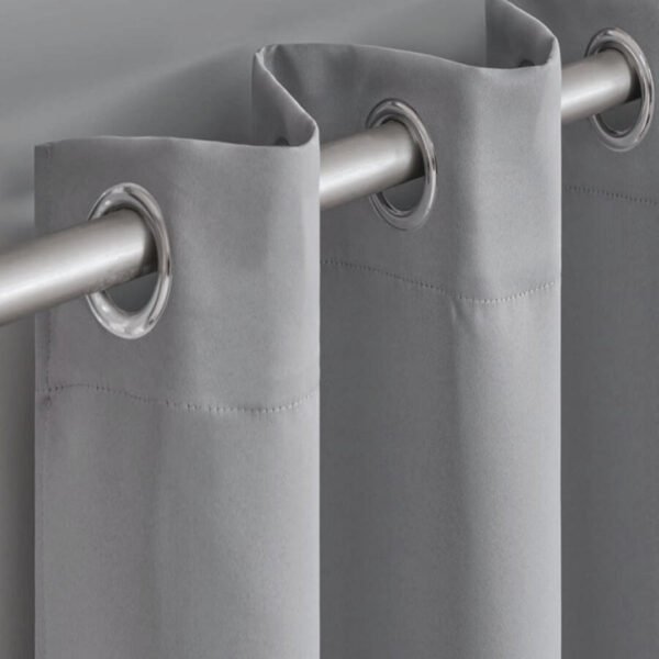 Close-up of eyelet rings on a blackout curtain, showing easy installation on a rod.