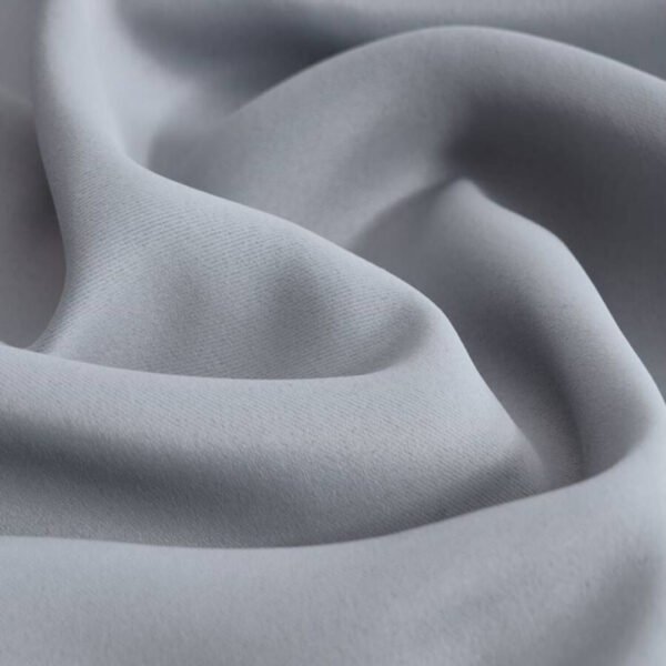 Close-up of durable polyester fabric of a blackout ring curtain, resistant to heat and sunlight.