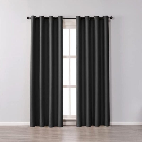 Blackout ring curtain in black against a gray background, placed in a living room.