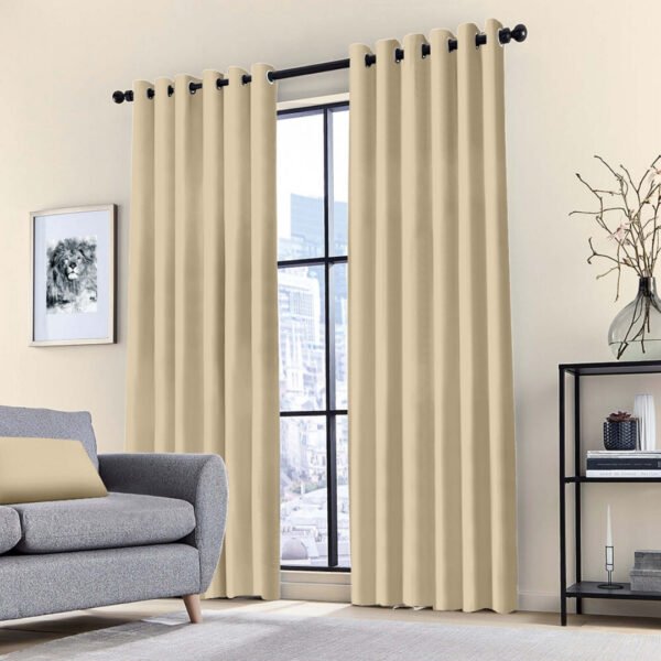 Blackout ring curtain in beige, providing thermal insulation and blocking sunlight in a bedroom.