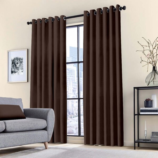 Blackout ring curtain in brown, designed with thermal insulation and sun-blocking features in a bedroom.