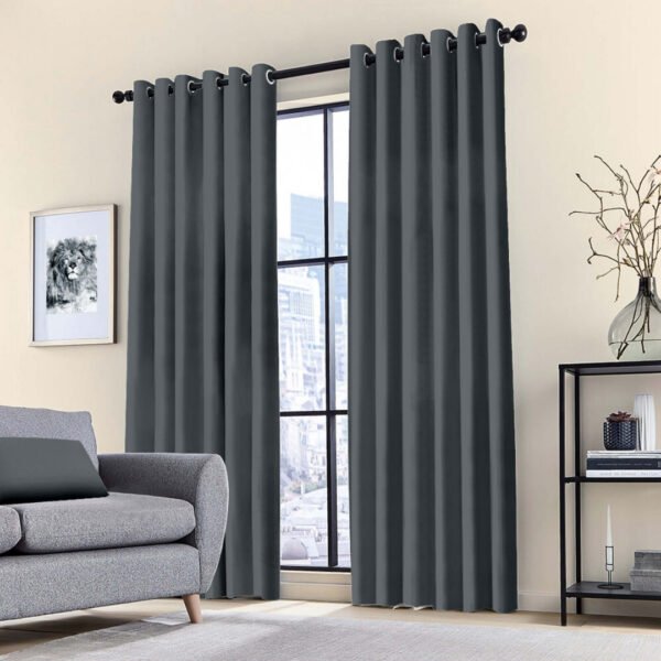 Blackout ring curtain in grey, with thermal insulation and sun-blocking features in a bedroom.