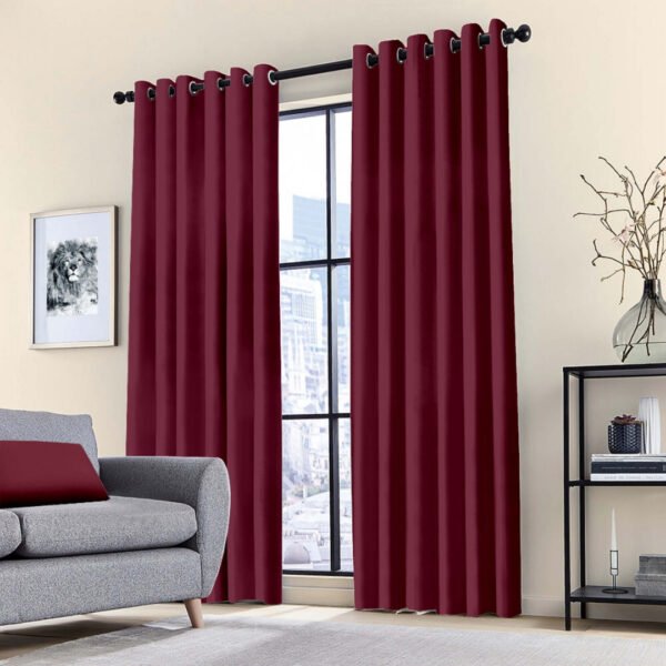 Blackout ring curtain in red, offering thermal insulation and sun-blocking in a bedroom.