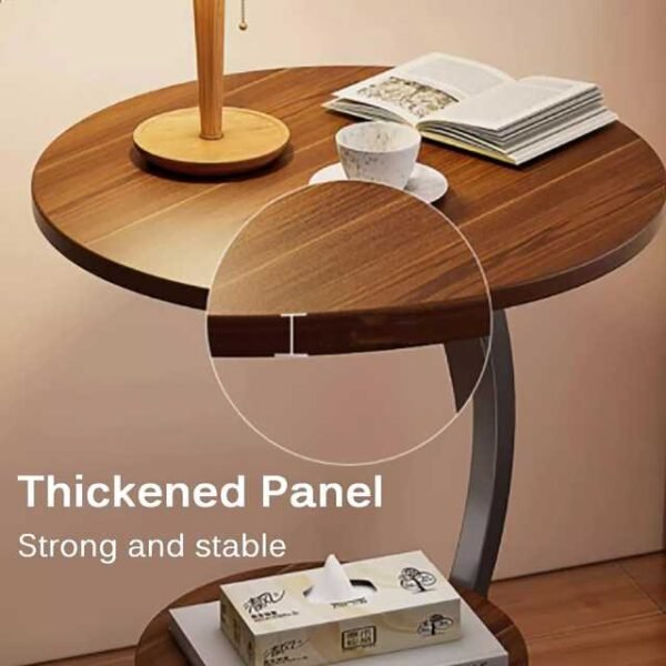 Bedroom end table with a thickened panel, holding coffee and books.