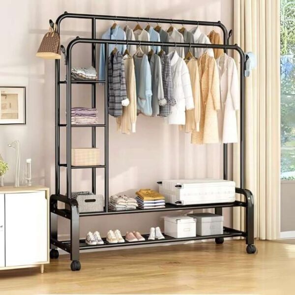 Double clothes rack in bedroom holding garments, shoes, and storage boxes.