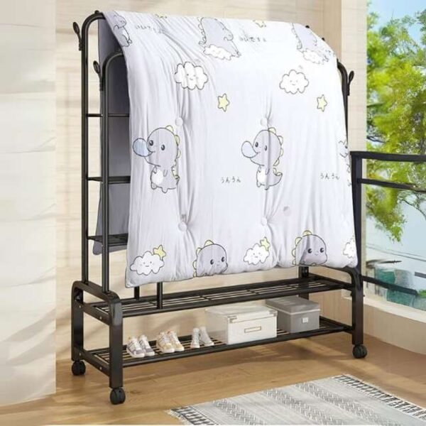 Double clothes rack placed outdoors holding a large blanket for drying.