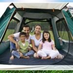 Family enjoying time inside a large camping tent for 4 people.