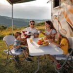 Family having fun with picnic table holding snacks.
