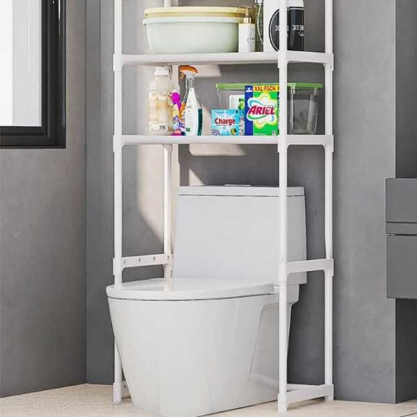 Over toilet storage shelf organizing cleaning supplies, towels, and accessories.