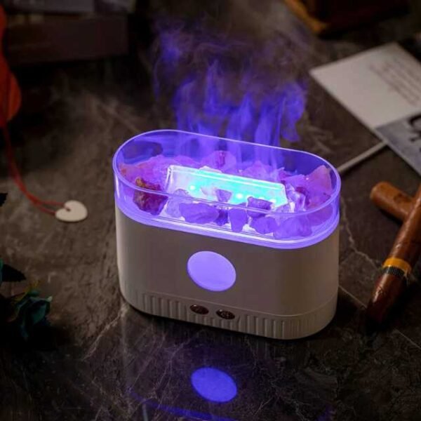 Aroma diffuser vaporizing essential oils into mist.