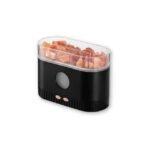 Black aroma diffuser with mineral salt on white background.
