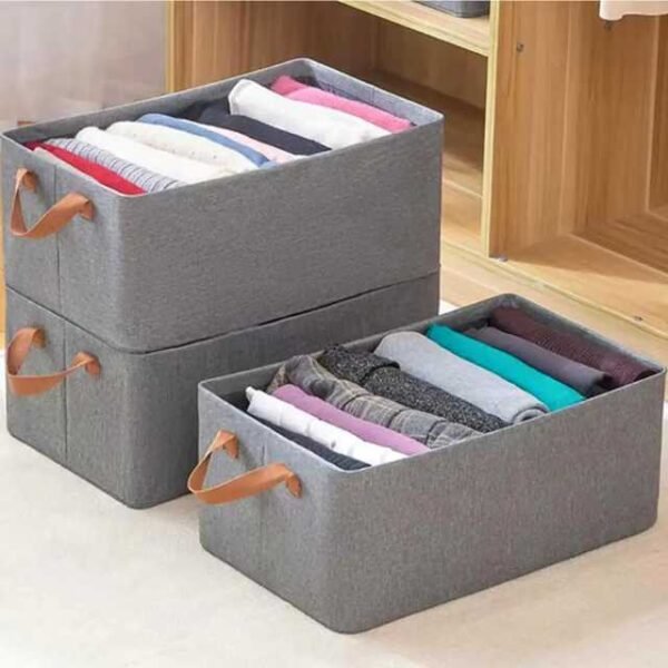 Collapsible clothes organizers in grey, holding clothes neatly.