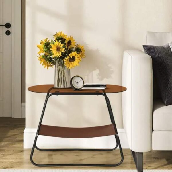 Brown glass side table with metal legs in a living room setting.