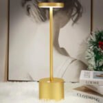 Gold modern table lamp on a table providing warm lighting in a home