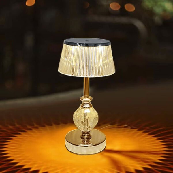 Golden crystal table lamp emitting a warm glow for romantic dining.