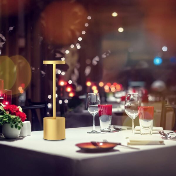 Gold modern table lamp on a restaurant dining table adding a magical touch.