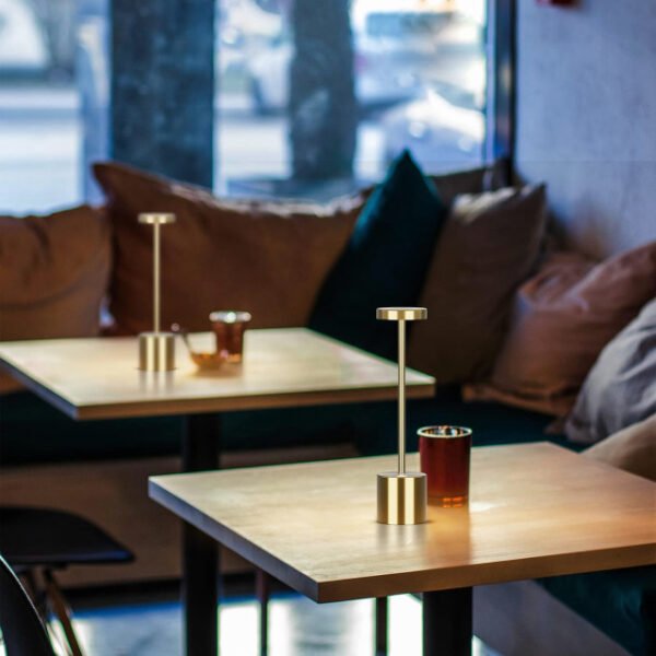 Modern table lamps on cafe tables providing a warm and memorable ambiance.