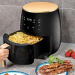 Silvercrest air fryer in black with crispy, oil-free French fries.