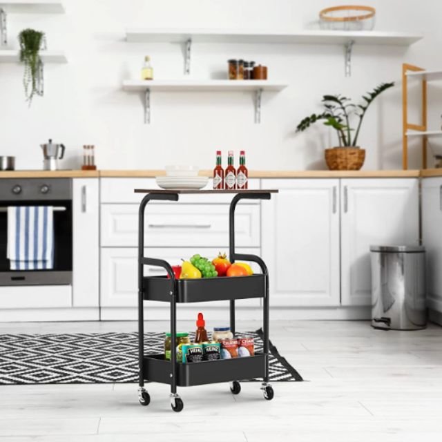 Black kitchen storage trolley holding fruit, spices, and utensils in an organized way.