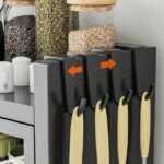 Kitchen cabinet featuring side hooks for hanging everyday utensils.