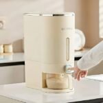Woman dispensing rice from UFORU rice dispenser with one-button operation.