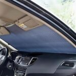Car sunshade curtain blocking harmful UV rays from windshield.
