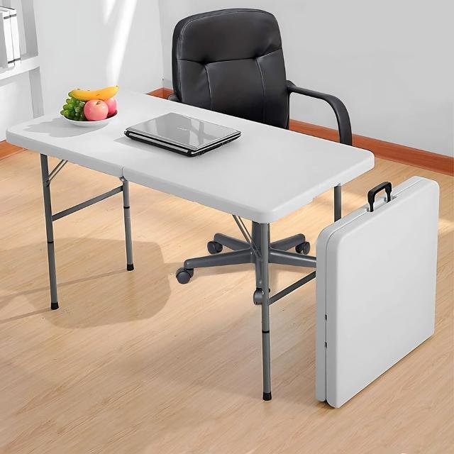 Folding work table with laptop and snacks in office.