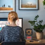 Woman using 3D flame heater at her desk for a cozy workspace.