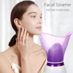 Woman touching face after using hot mist facial steamer.