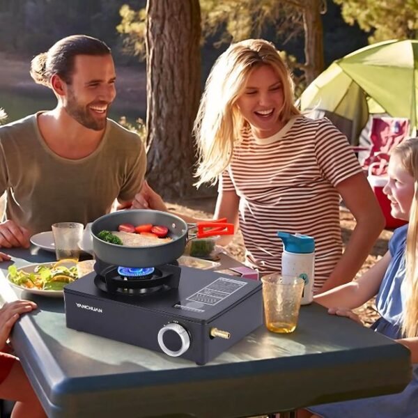 Family enjoying outdoor meal cooked on a modern camping stove.