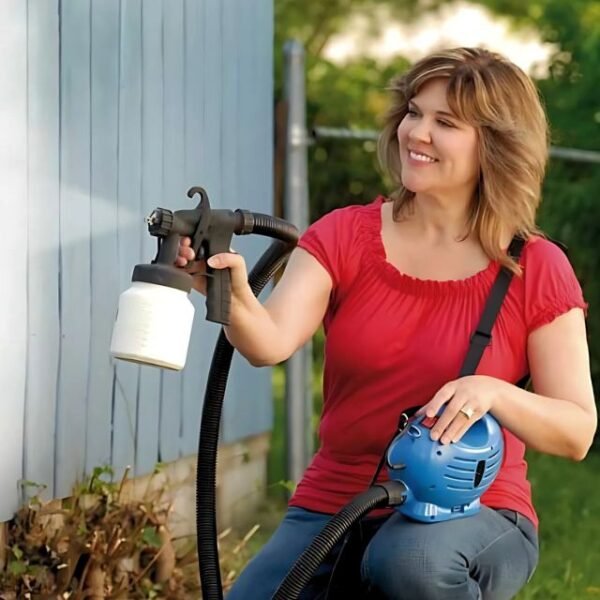 Woman painting outdoors with Paint Zoom electric spray painter.