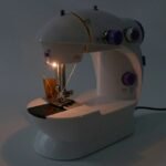 Portable sewing machine with built-in night light for easy use at night.
