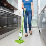 Woman using X5 steam cleaner on kitchen floors for a spotless clean.