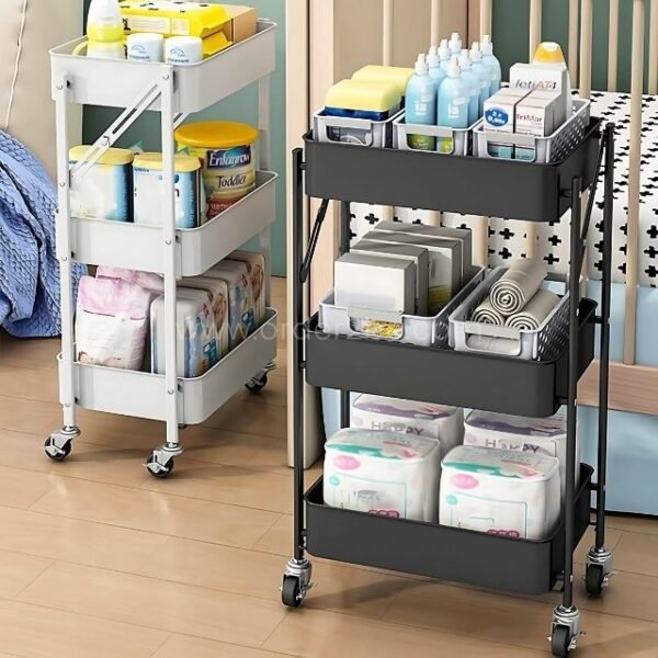 Rolling storage carts filled with baby essentials, including diapers, bottles, and wipes, placed next to a crib in a nursery setting.