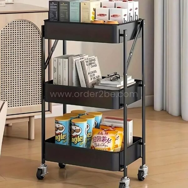 Black cart with tea, books, and snacks on three tiers, ideal for multifunctional home storage.