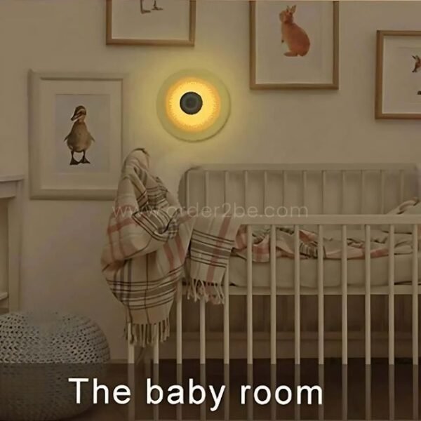 Motion sensor lamp glowing softly above a crib in a baby room.