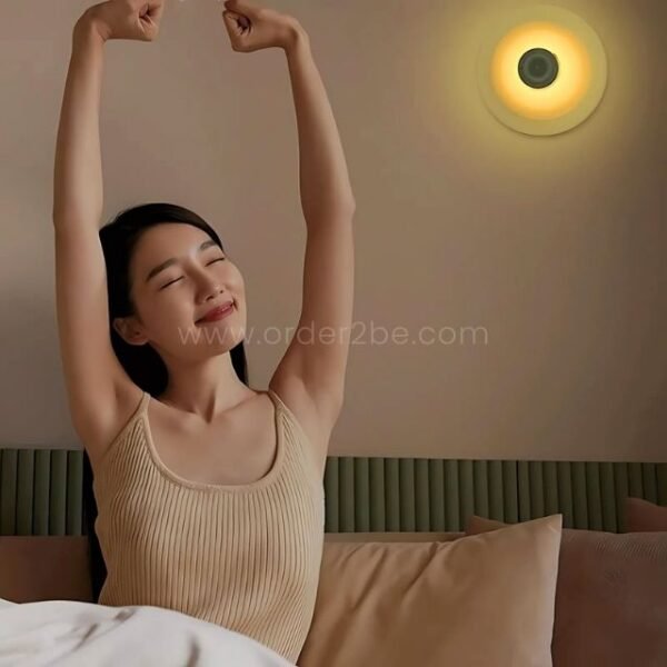 Motion sensor lamp providing warm light in a modern bedroom.