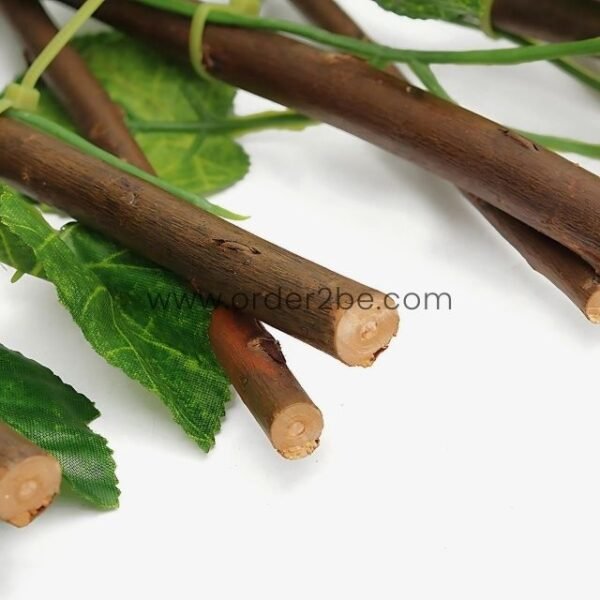 Wooden canes with green plastic leaves attached, showing the material combination used in the expandable garden fence.