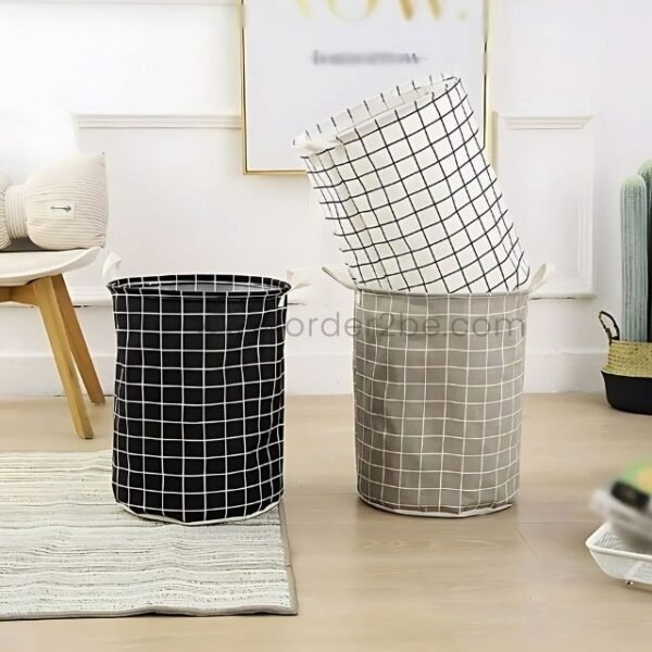 Trio of laundry baskets in black, white, and grey with grid patterns, displayed in a modern room.