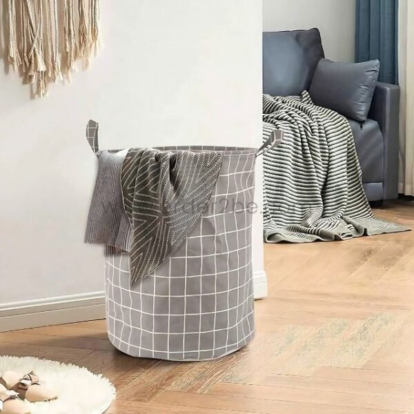 Grey laundry basket with grid pattern and carry handles, adding style and storage to a cozy living room.