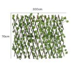 Expandable garden fence with green leaves on wooden slats, displayed on a white background with dimensions of 300 cm width and 70 cm height.
