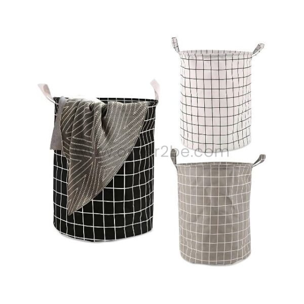 Three foldable laundry bags in grey, white, and black, neatly displayed in a minimalist room.