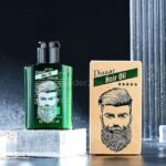 A green bottle of Disaar hair oil with a black pump, paired with beige packaging featuring a man’s well-groomed hair and beard illustration.